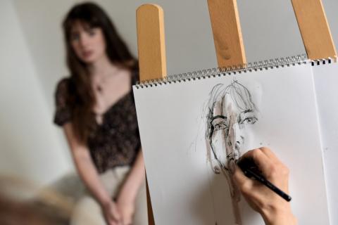 artist drawing portrait of woman